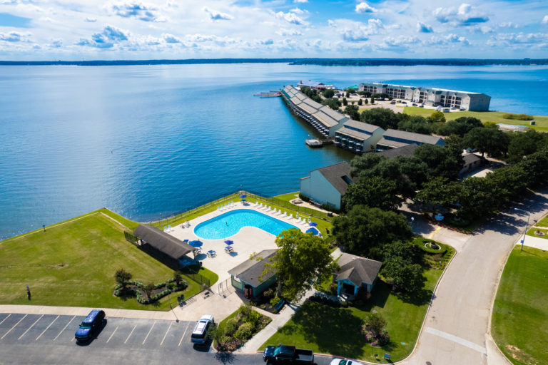 Photo of swimming pool with the resort in the background. Aerial view.